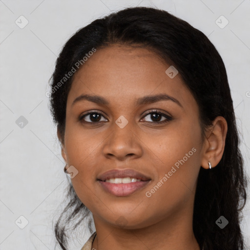 Joyful black young-adult female with long  black hair and brown eyes