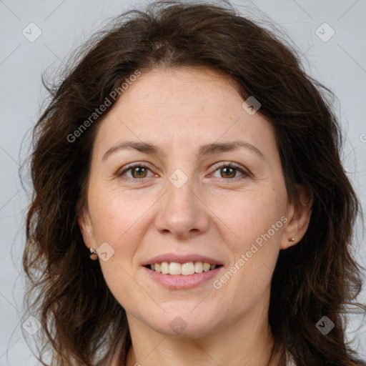 Joyful white adult female with long  brown hair and brown eyes