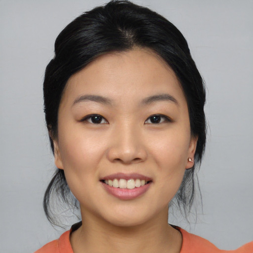 Joyful asian young-adult female with medium  black hair and brown eyes
