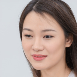 Joyful asian young-adult female with long  brown hair and brown eyes