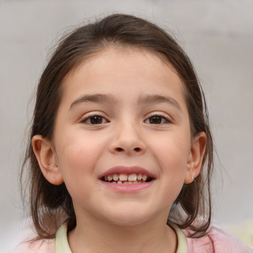 Joyful white child female with medium  brown hair and brown eyes