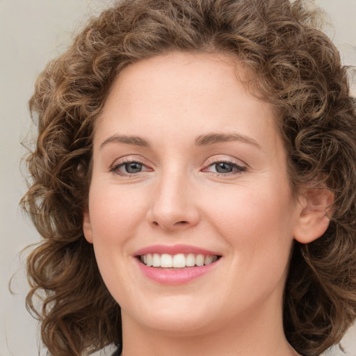 Joyful white young-adult female with medium  brown hair and green eyes