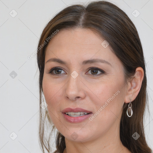 Joyful white adult female with medium  brown hair and brown eyes