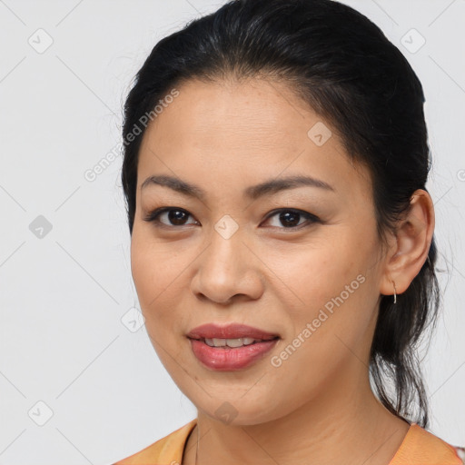 Joyful latino young-adult female with medium  brown hair and brown eyes