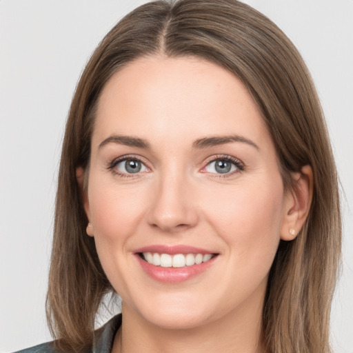 Joyful white young-adult female with long  brown hair and grey eyes