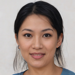 Joyful asian young-adult female with medium  black hair and brown eyes