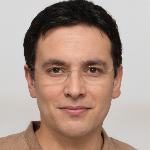 Joyful white adult male with short  black hair and brown eyes