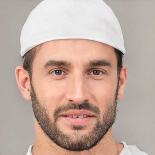 Joyful white young-adult male with short  black hair and brown eyes