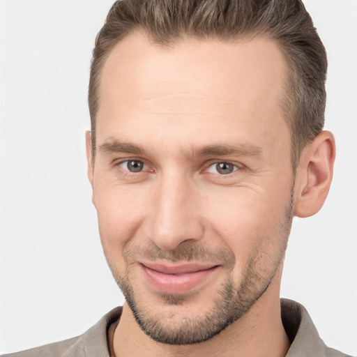 Joyful white young-adult male with short  brown hair and brown eyes