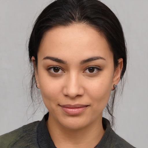 Joyful latino young-adult female with medium  brown hair and brown eyes