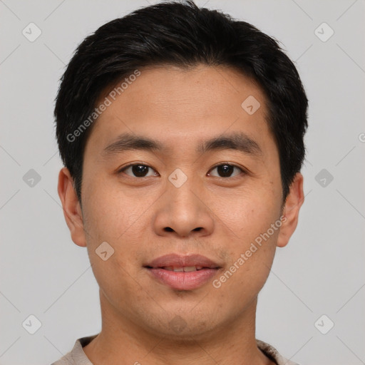 Joyful asian young-adult male with short  black hair and brown eyes