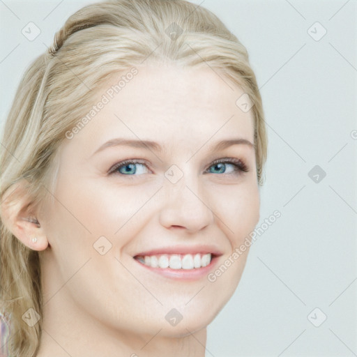 Joyful white young-adult female with long  blond hair and blue eyes