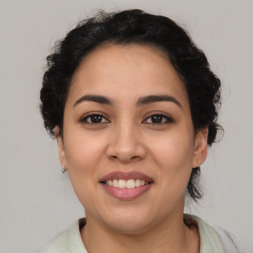 Joyful latino young-adult female with medium  brown hair and brown eyes