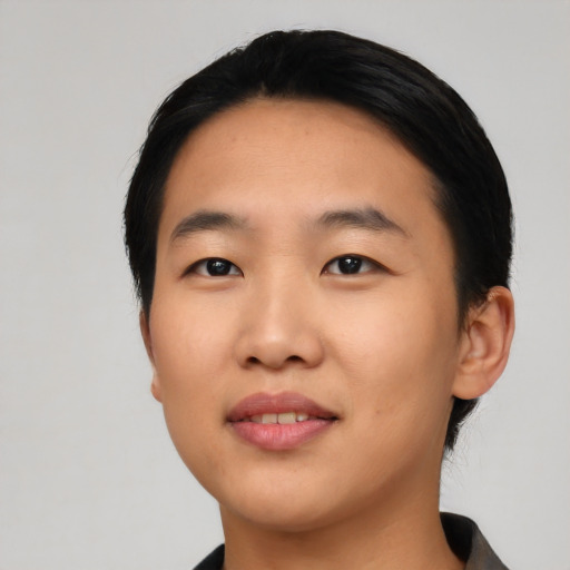 Joyful asian young-adult female with short  black hair and brown eyes