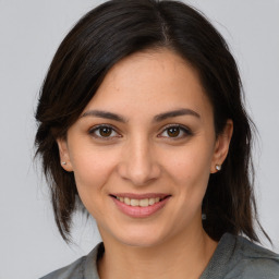 Joyful white young-adult female with medium  brown hair and brown eyes