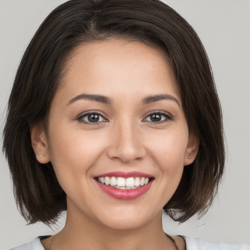 Joyful white young-adult female with medium  brown hair and brown eyes