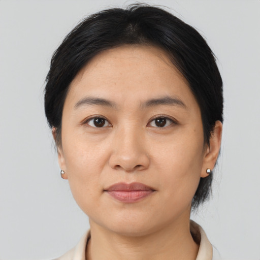 Joyful asian young-adult female with medium  brown hair and brown eyes