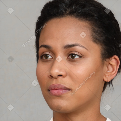 Joyful black young-adult female with short  black hair and brown eyes