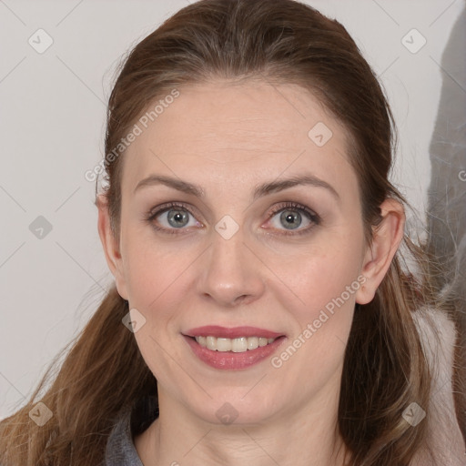 Joyful white young-adult female with long  brown hair and grey eyes