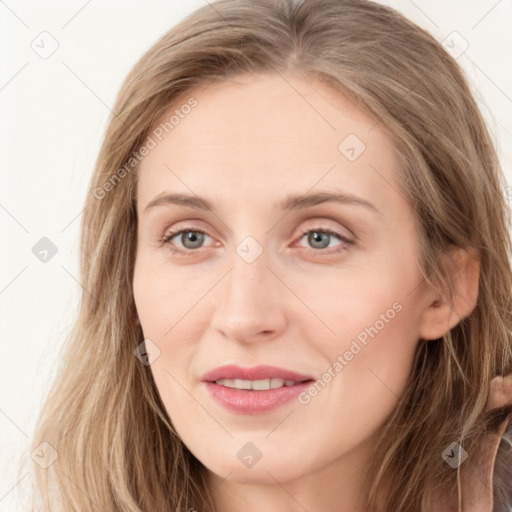 Joyful white young-adult female with long  brown hair and blue eyes