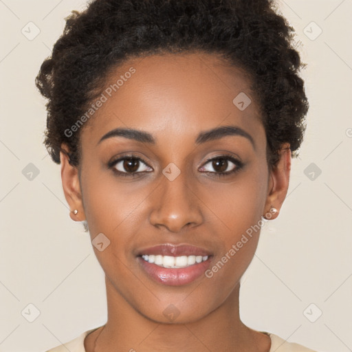 Joyful black young-adult female with short  brown hair and brown eyes