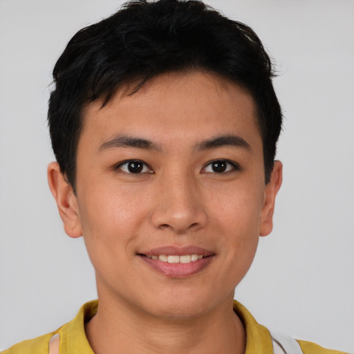 Joyful asian young-adult male with short  brown hair and brown eyes