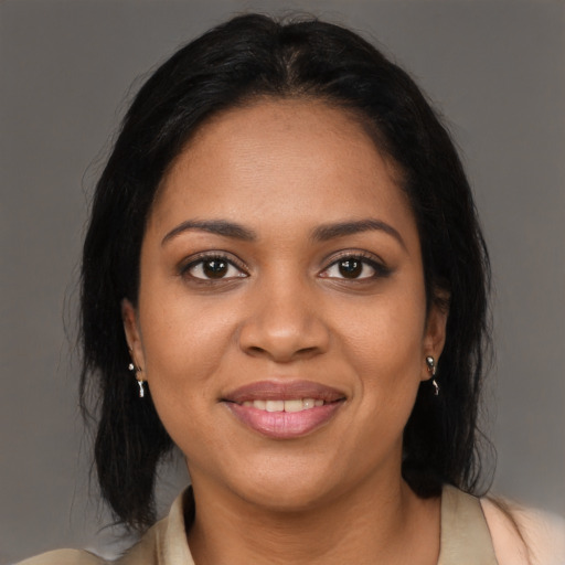 Joyful black young-adult female with medium  brown hair and brown eyes
