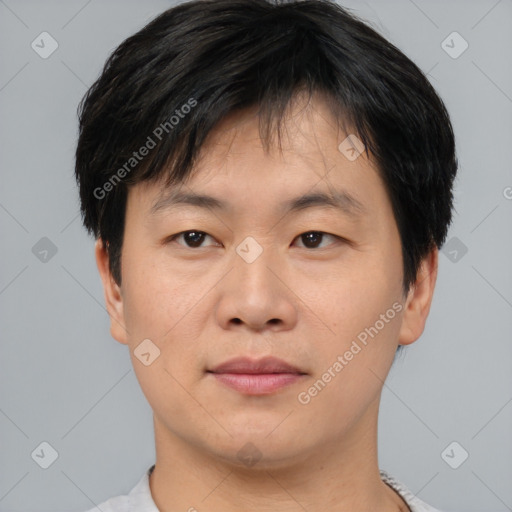 Joyful asian young-adult male with short  brown hair and brown eyes