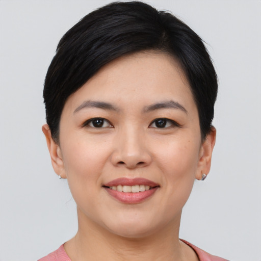 Joyful asian young-adult female with short  black hair and brown eyes