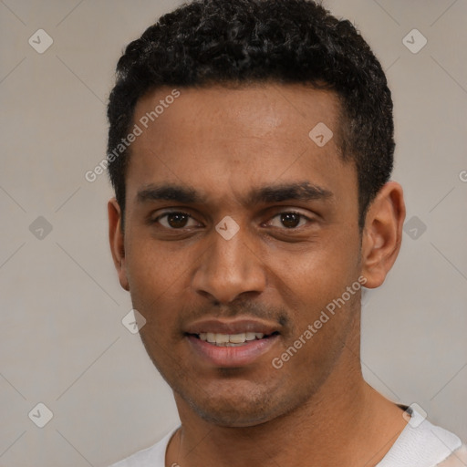 Joyful black young-adult male with short  black hair and brown eyes