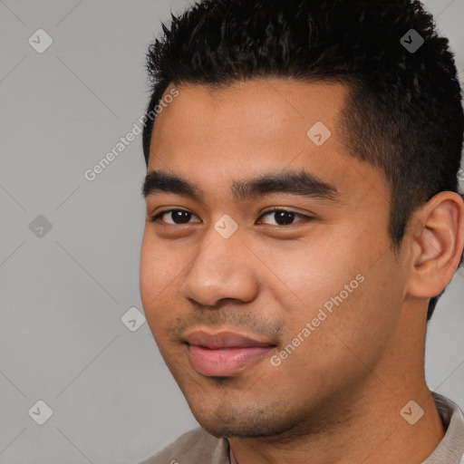 Joyful latino young-adult male with short  black hair and brown eyes