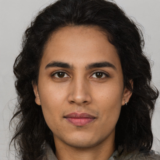 Joyful latino young-adult female with long  brown hair and brown eyes