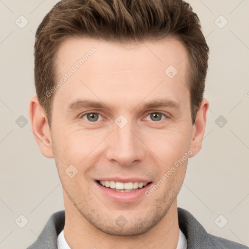 Joyful white young-adult male with short  brown hair and grey eyes