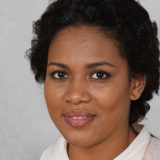 Joyful black young-adult female with medium  brown hair and brown eyes
