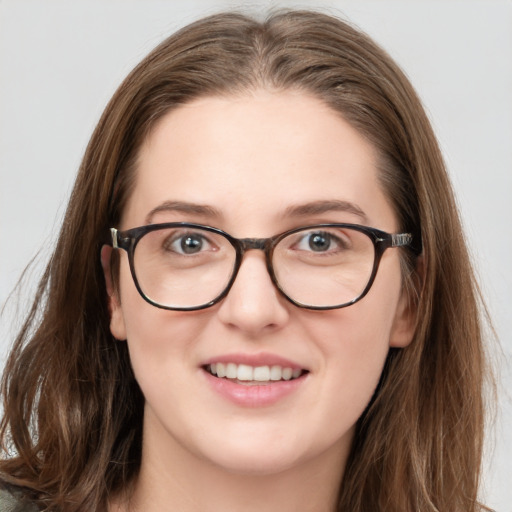 Joyful white young-adult female with long  brown hair and blue eyes