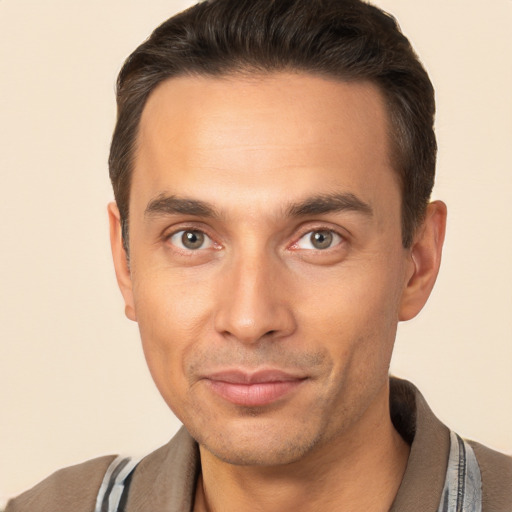 Joyful white adult male with short  brown hair and brown eyes