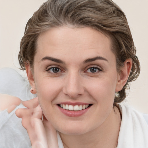 Joyful white young-adult female with medium  brown hair and brown eyes