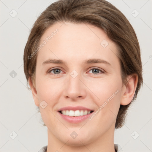 Joyful white young-adult female with medium  brown hair and grey eyes