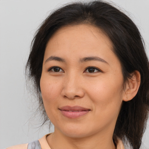 Joyful asian young-adult female with medium  brown hair and brown eyes