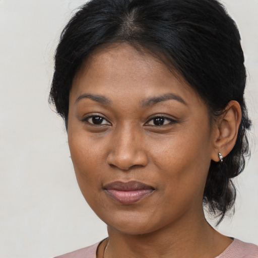 Joyful black young-adult female with medium  brown hair and brown eyes