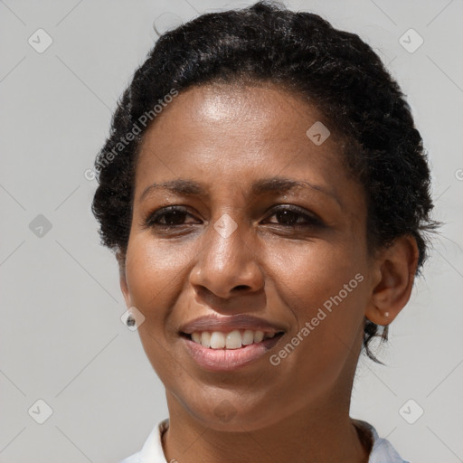 Joyful black adult female with short  brown hair and brown eyes