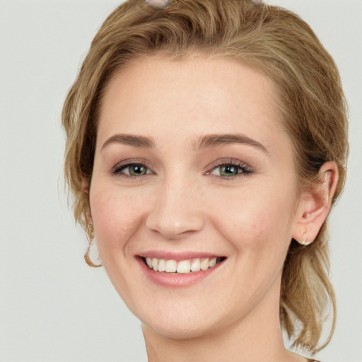 Joyful white young-adult female with long  brown hair and green eyes