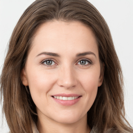 Joyful white young-adult female with long  brown hair and grey eyes