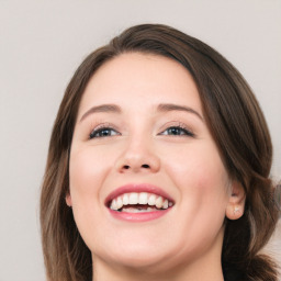 Joyful white young-adult female with long  brown hair and blue eyes