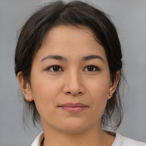 Joyful asian young-adult female with medium  brown hair and brown eyes
