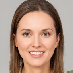 Joyful white young-adult female with long  brown hair and green eyes