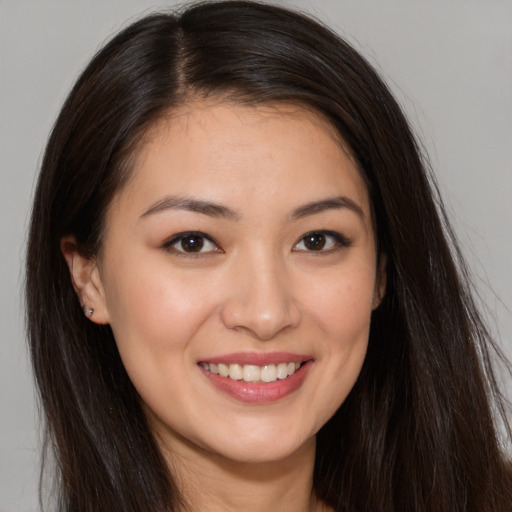 Joyful white young-adult female with long  brown hair and brown eyes