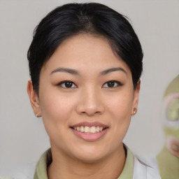 Joyful asian young-adult female with short  brown hair and brown eyes