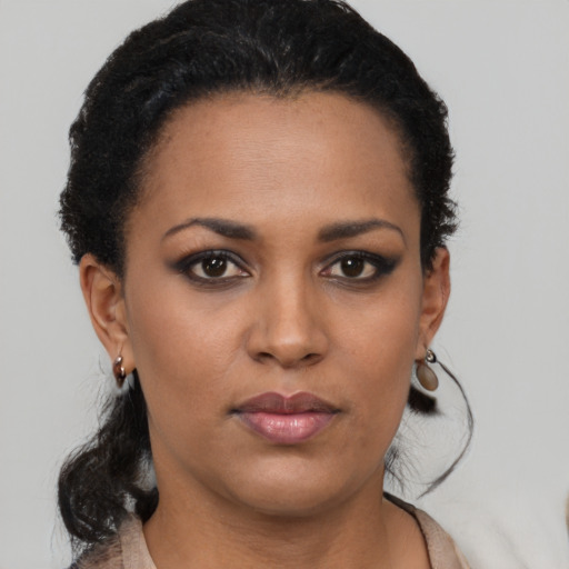 Neutral black young-adult female with medium  brown hair and brown eyes