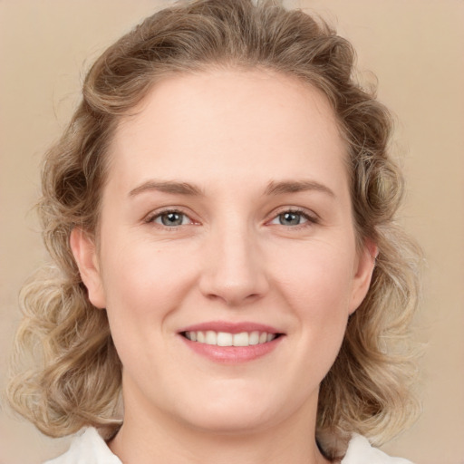 Joyful white young-adult female with medium  brown hair and blue eyes